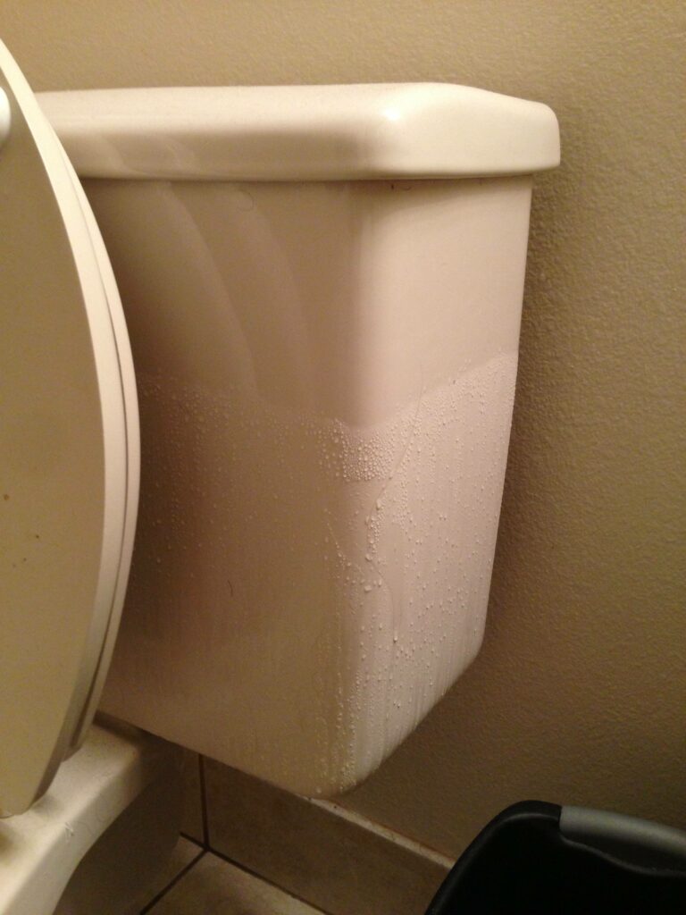 Toilet tank with condensation.